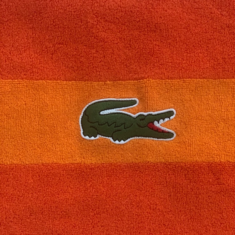 Brand new Lacoste orange towel